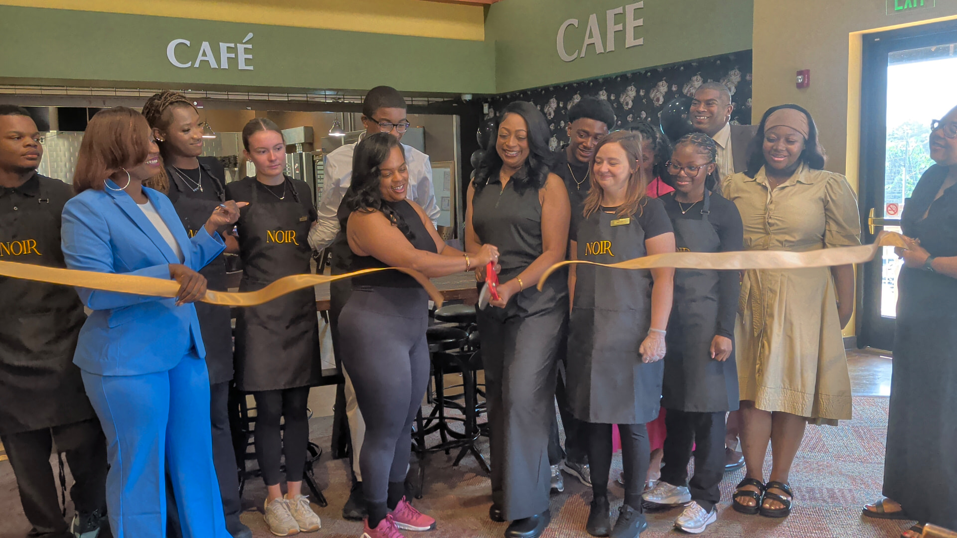 Ribbon cutting at NOIR Café inside the Hoover Public Library with the owners and staff