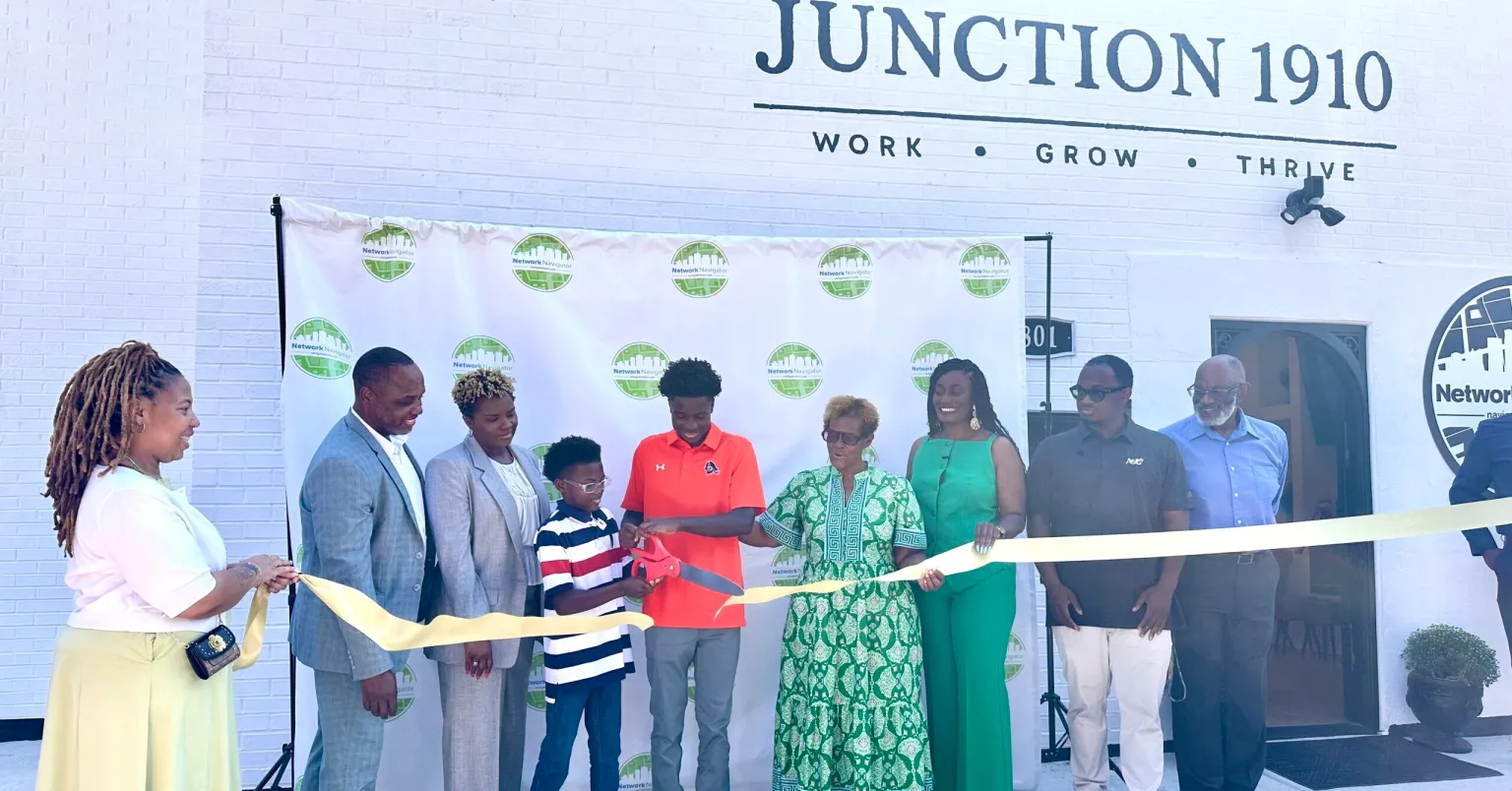 Community leaders and family cut the ribbon outside Junction 1910 on September 14
