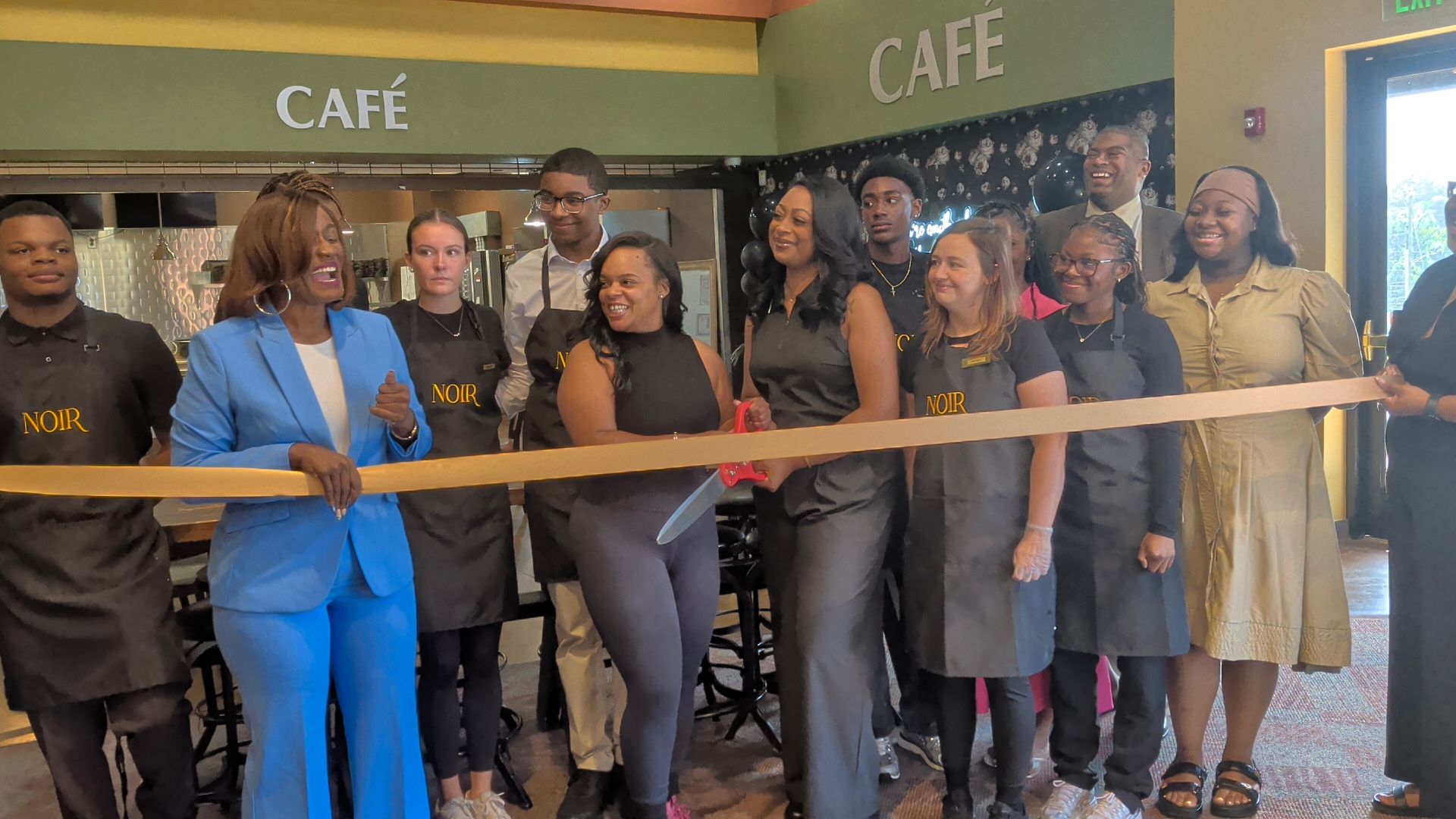 Pauline's and LaFleur Coffee teams cutting the ribbon at NOIR Cafe in the Hoover Library